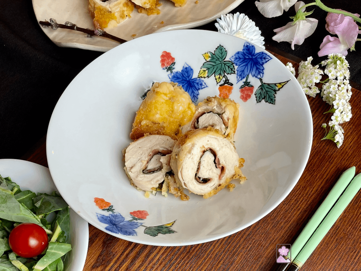 Japanese Style Chicken Rollup, cut into 4 slices on a ceramic plate