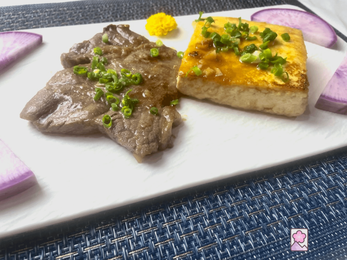 Flavorful and delicious Wagyu and Tofu Steak in Japanese Fish Sauce Placed on a rectangular ceramic plate.