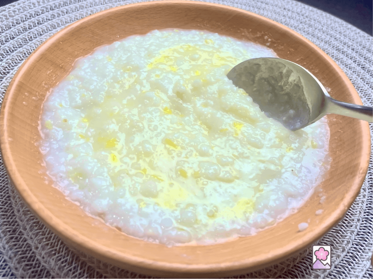 Hominy Grits in a wooden bowl topped with butter