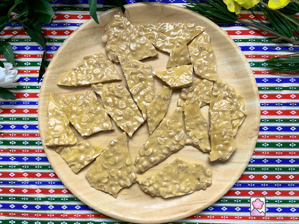 Crunchy Peanut Brittle on a Wooden plate.