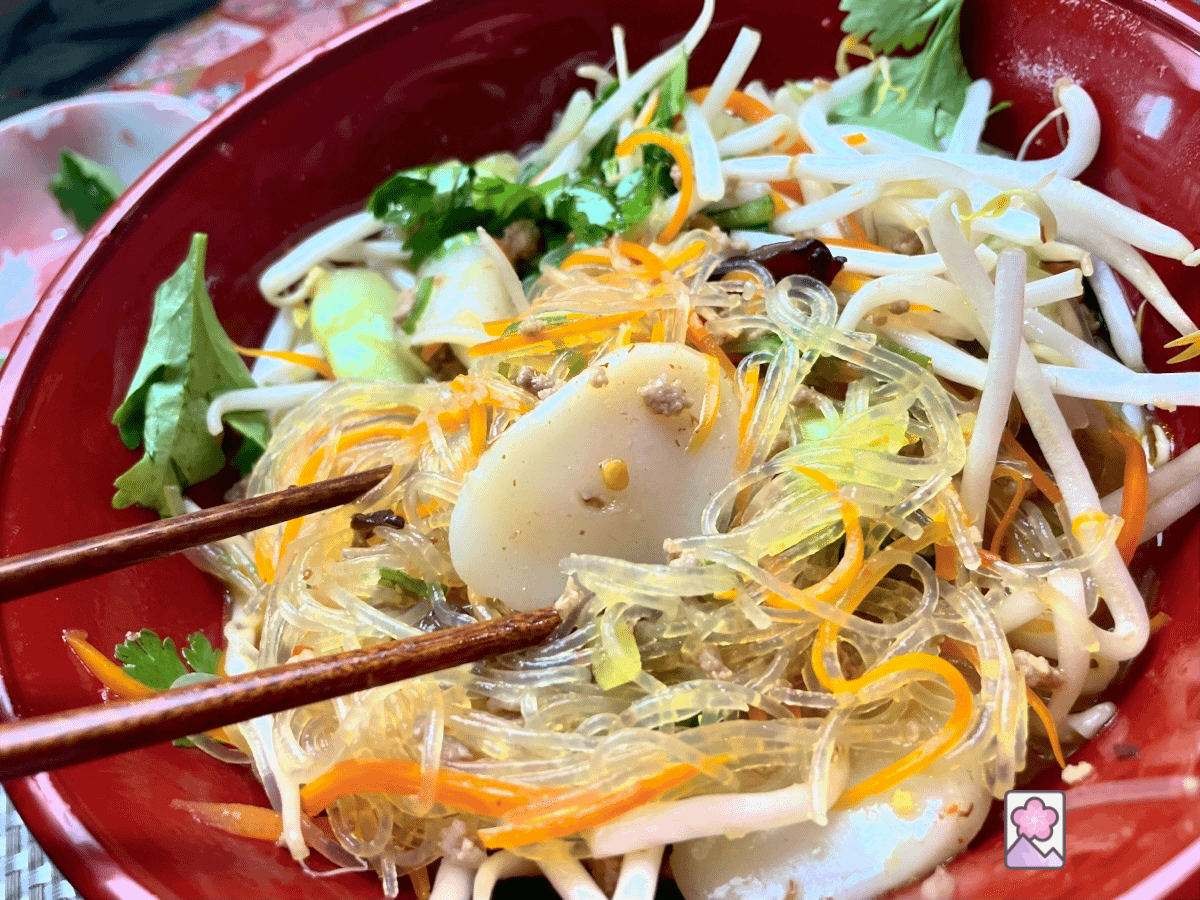 Pork Beefun with Tteok is topped off with corriander and bean sprouts and served hot in a Chinese Noodle bowl