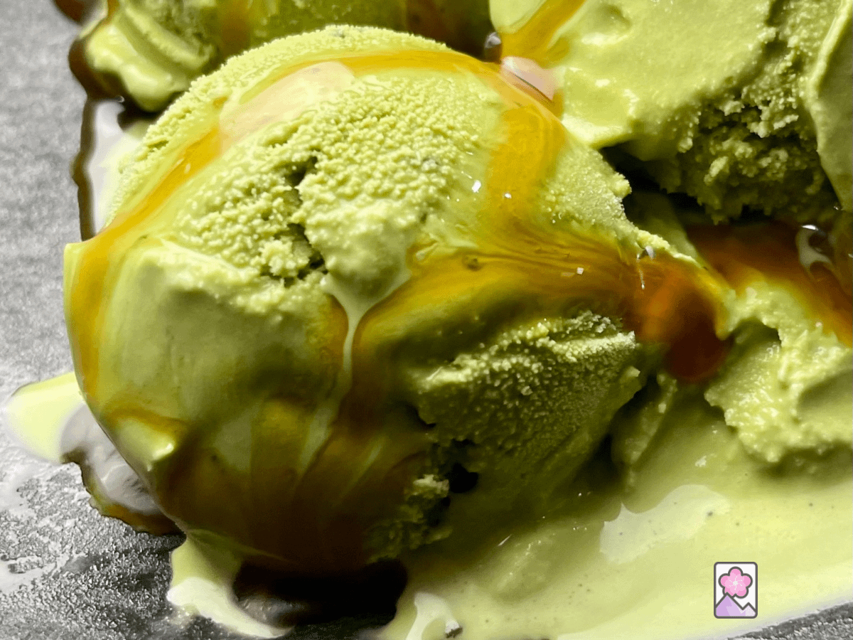 Lucious and Creamy Matcha Ice Cream drizzled with caramel sauce in a bowl