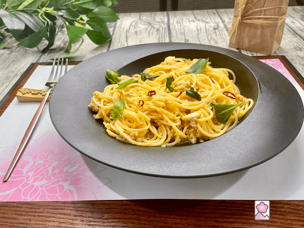 Lemony Crabmeat Spaghetti topped with basil and red pepper flakes in a decorative bowl