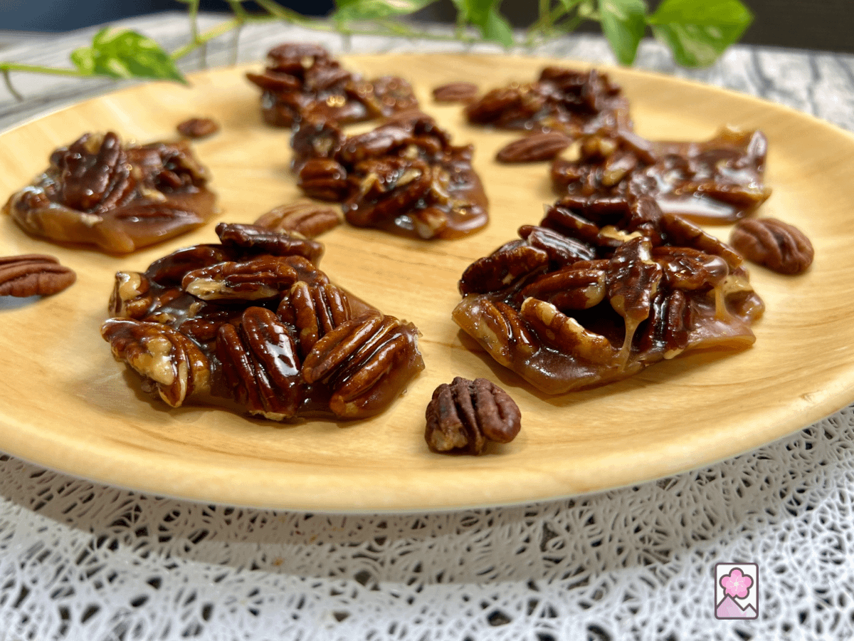 Chewy Caramel Pecan Chews on a plate with pecans.