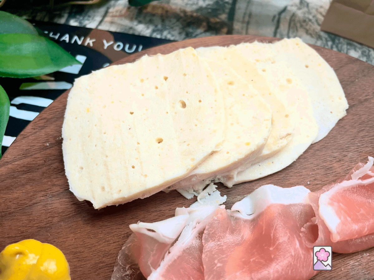 Moist and delicious, this Old Fashioned chicken breast is sliced thin and laid out on a circular wooden cutting board