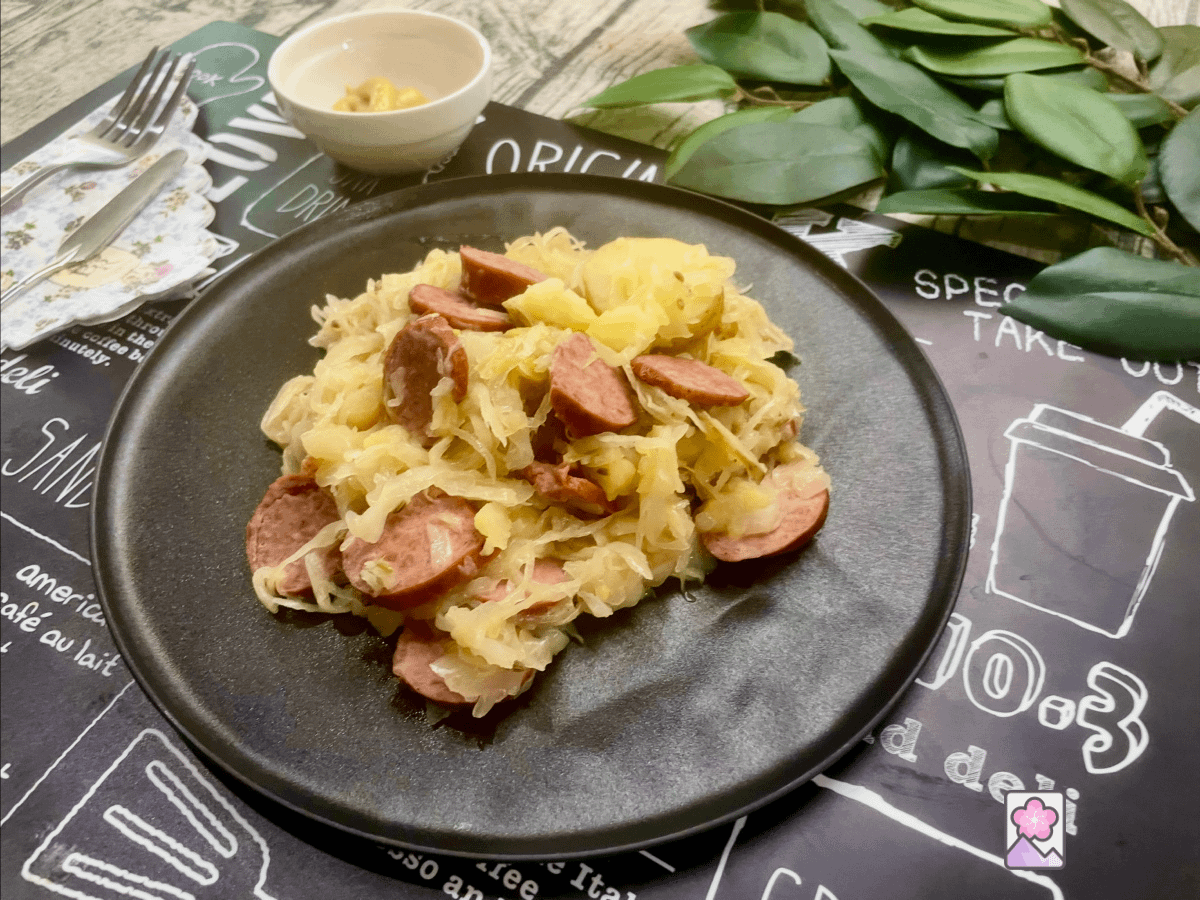 Polish Kielbasa and Sauerkraut Skillet on a plate, with mustard and a fork in the background