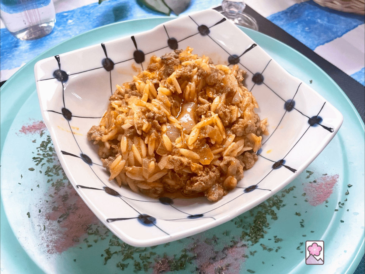 Youvetsi, Lamb and Orzo casserole is served in a square ceramic bowl
