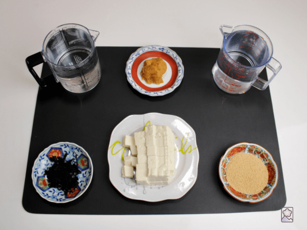 Miso Soup ingredients laid out on a black mat