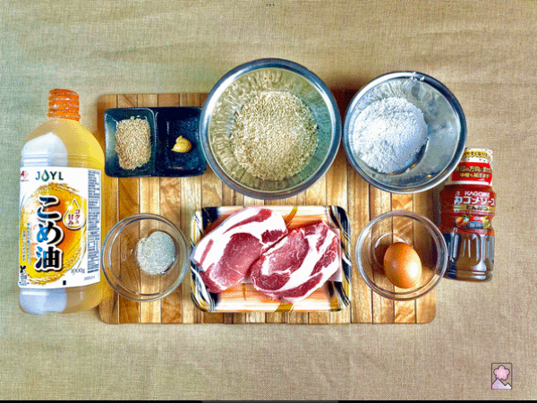 Tonkatsu ingredients as listed arranged on a board. Shredded cabbage is not shown.