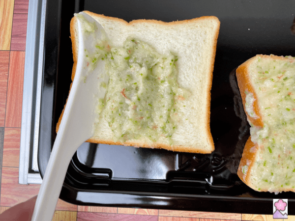 Spreading the shrimp paste on a slice of bread