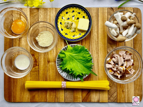 Ingredients for Bacon Kinoko Pasta on a wooden board