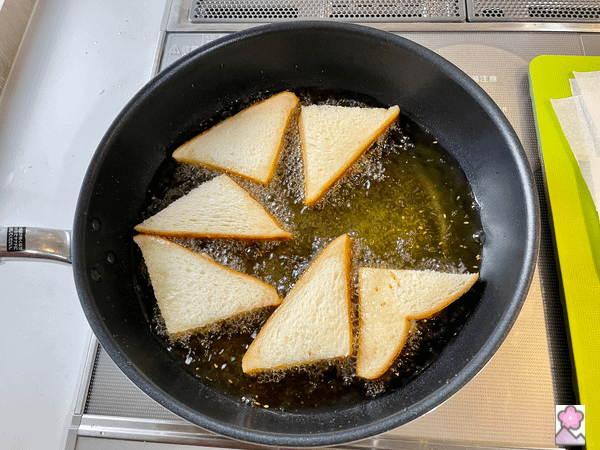 Frying the shrimp toast, paste side down