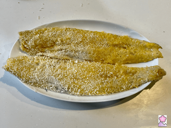 Suzuki fillets breaded on a plate