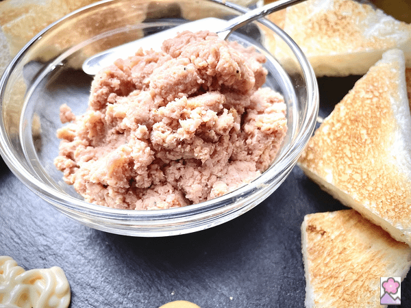 Homestyle Deviled Ham in serving bowl With a knife for spreading it and toast points in the background
