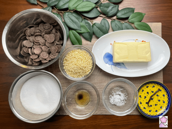Ingredients for Toffee lined up on a wood board with green leaves in the background.