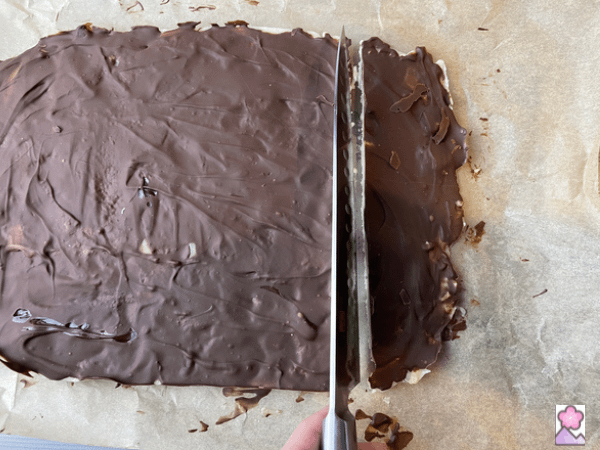 Cutting the toffee into bars with a large knife
