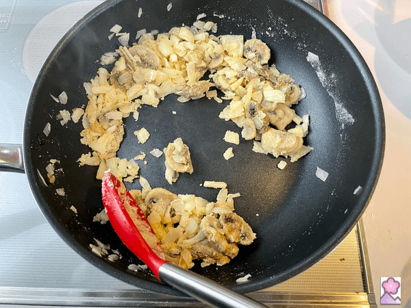 Flour and onions and mushrooms in a frypan