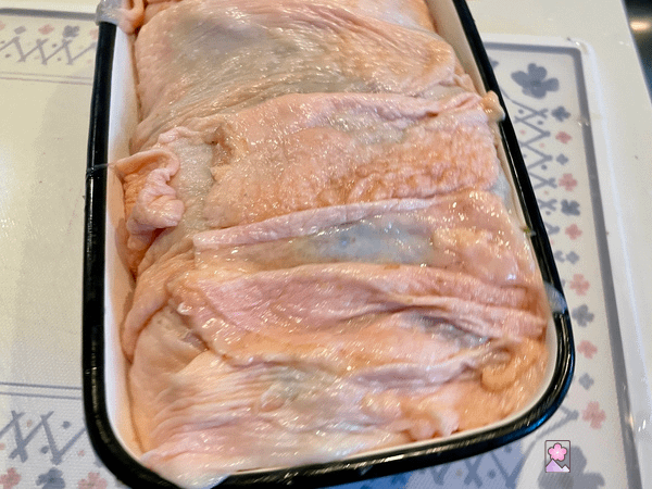 Chicken loaf in the terrine with the skin encircling it.