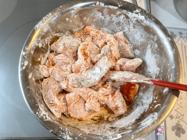 Salmon in a metal bowl coated with potato starch