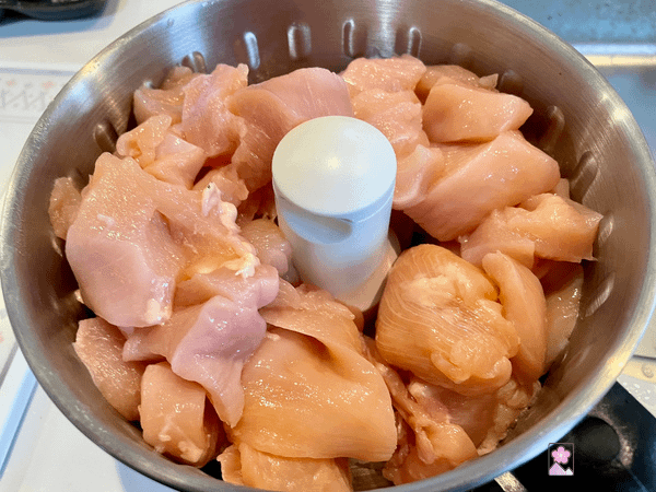 Chicken breast diced into one inch cubes in a food processor.