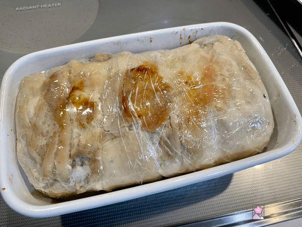 Chicken loaf wrapped in plastic and placed back in the terrine pan, now ready to refrigerate
