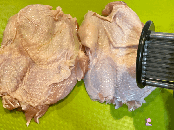 Using a tenderizer to poke holes in the meat