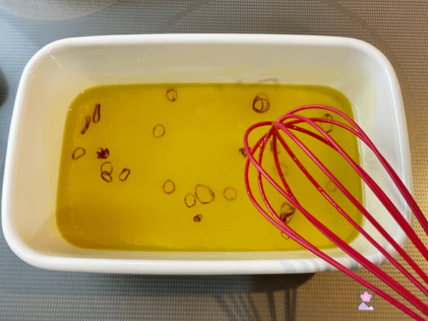 Oyster marinade in a pan with a whisk