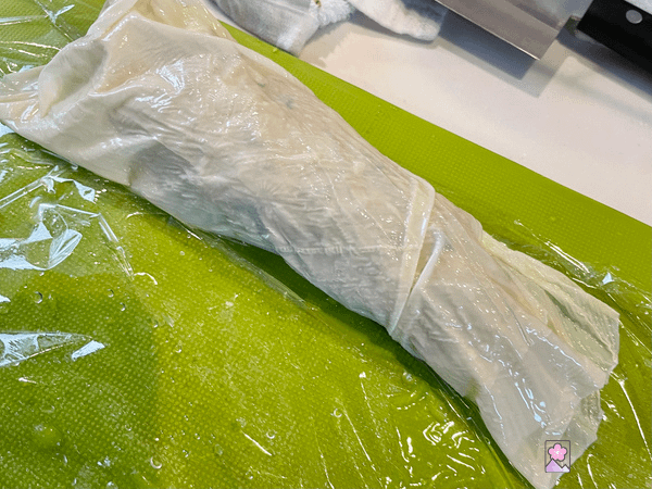 Rolled up yuba On plastic wrap