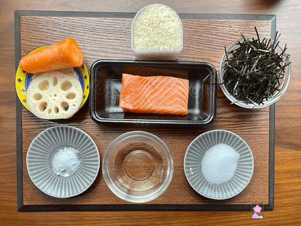 Ingredients for Salmon Sushi Rice placed on a wooden tray