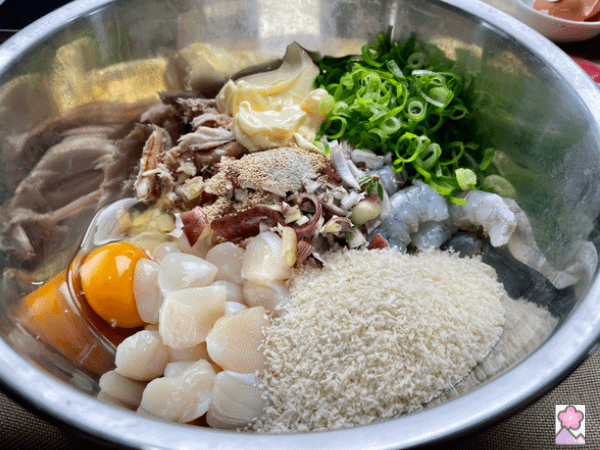 Combined shellfish cake ingredients in a metal mixing bowl