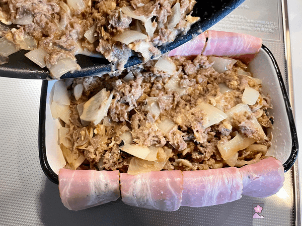 Preparing the terrine by adding the filling