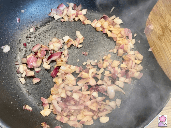 Sautéed red onion in a skillet