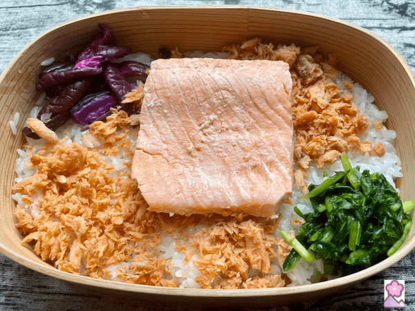 Salmon on the salmon flakes over a bed of sushi rice