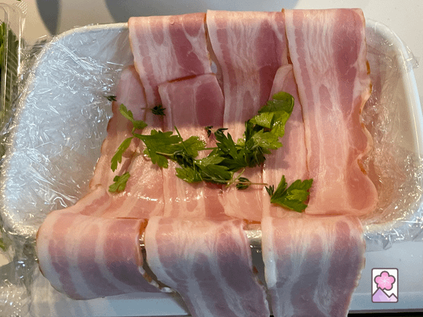 Plastic wrap, bacon and herbs in a terrine pan
