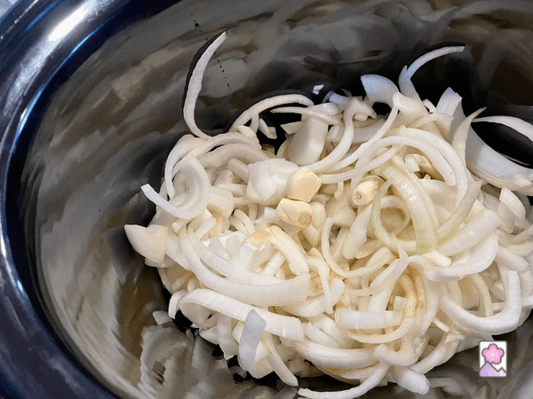 Onions broken up into threads in a slow cooker