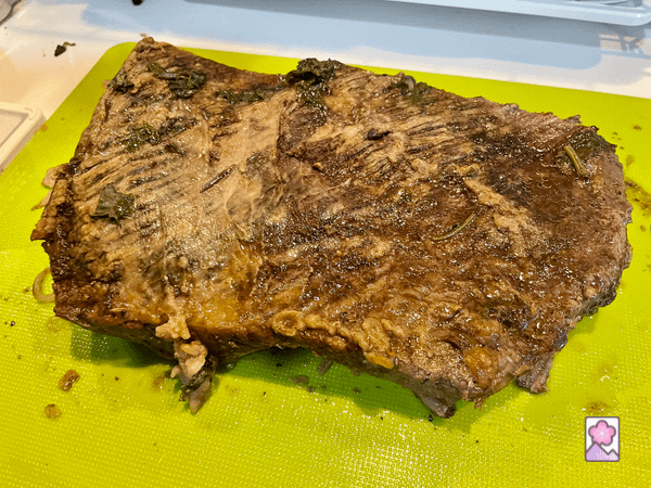 Slow Cooker Beef Brisket resting on a cutting board after cooking