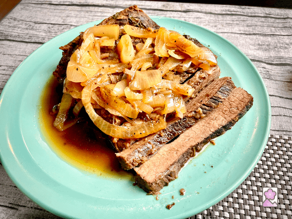 Sliced brisket on a serving plate.