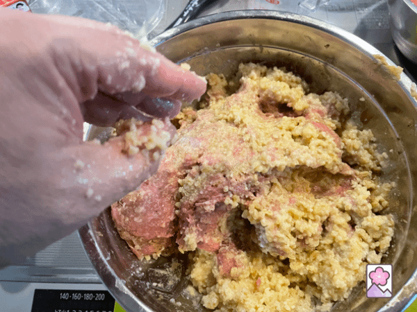 Kneading bulgur dough in a metal bowl by hand