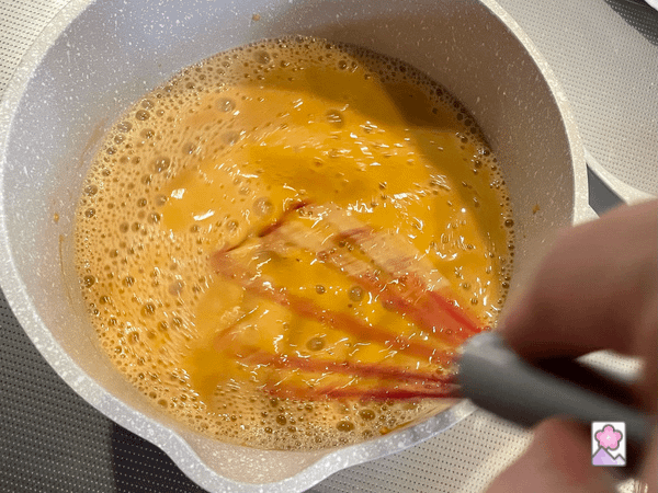 Peanut butter mixed into the sugar and water in a saucepan