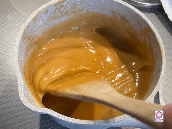 Thickened peanut mixture Being stirred in a saucepan