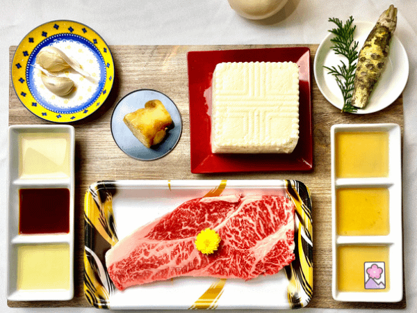 Ingredients for Wagyu and Tofu Steak in Ja-anise Fish Sauce on a board