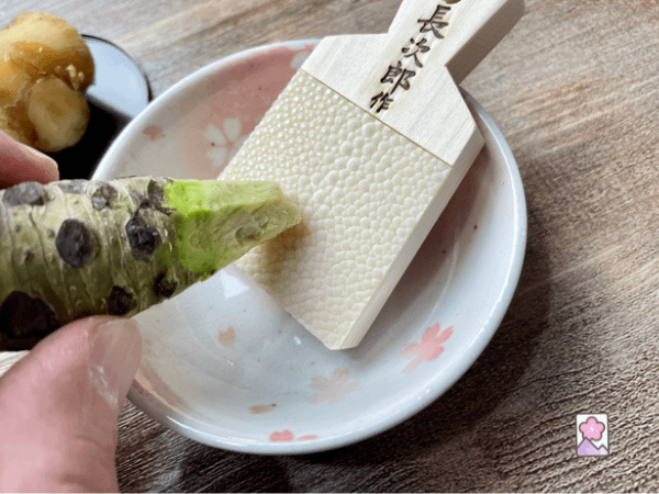 Grating fresh wasabi using a sharkskin grater
