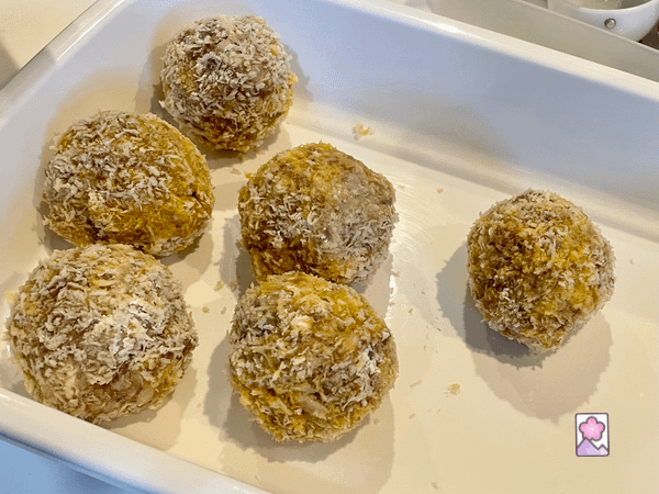 6 six mini scotch eggs rolled up and breaded in a plastic container