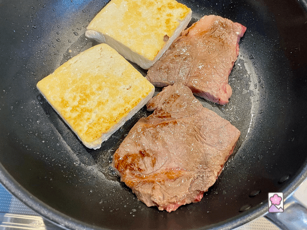 Cooked beef and tofu steak in a frypan