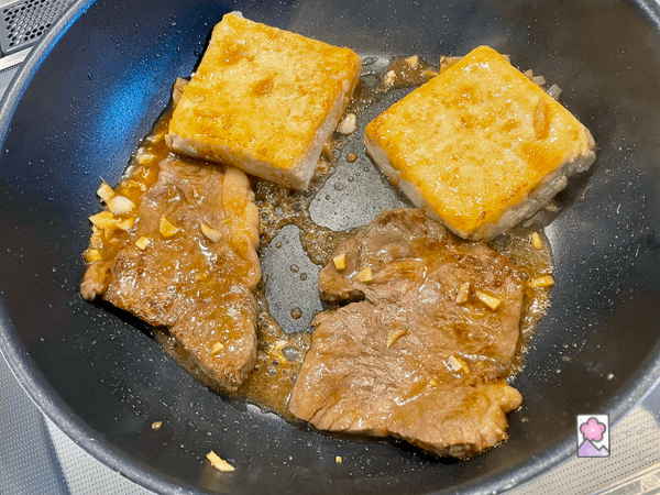 Wagyu and Tofu steak simmering in fish sauce