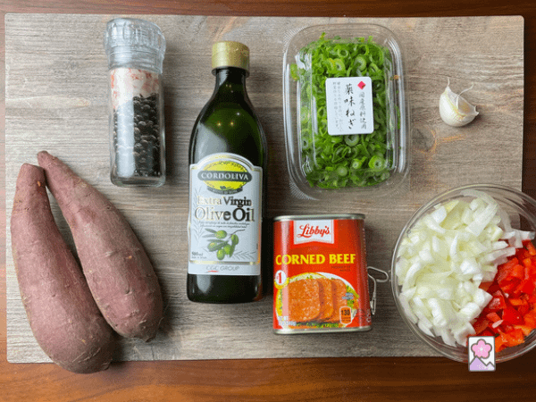 Corned Beef Hash with Japanese Sweet Potatoes ingredients laid out on a wood board
