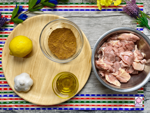 Ingredients for Chicken Shawarma on a wooden board