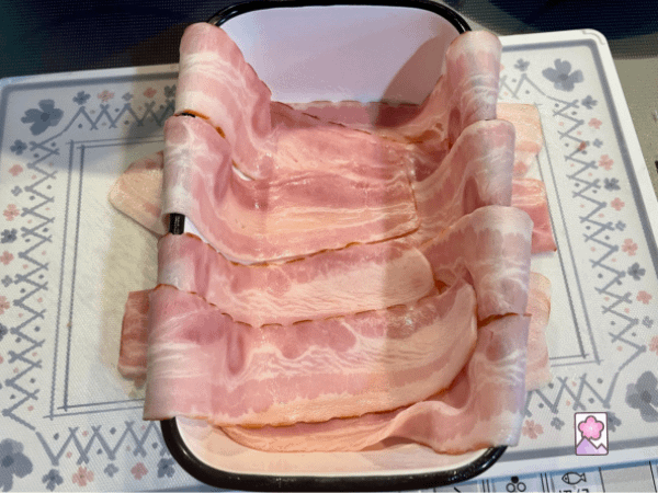 A loaf pan is lined with bacon