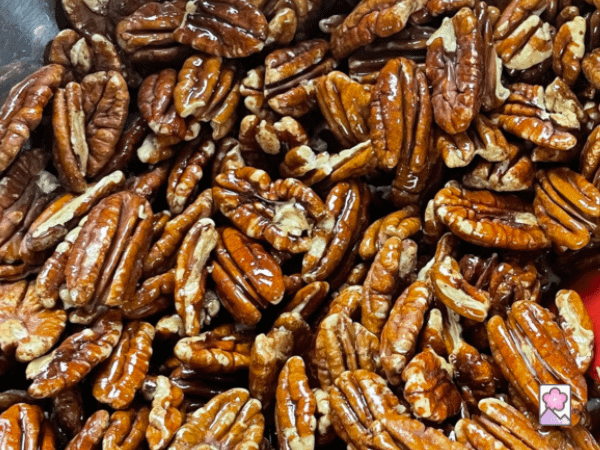 Close up of pecans that have been coated with butter
