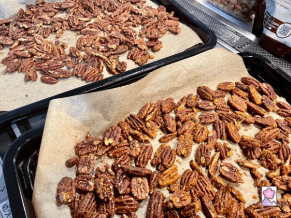 Maple glazed pecans cooling on two baking sheets